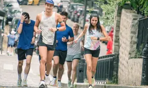 Un groupe de coureurs s'entraîne dans les rues pavées, une course qui rappelle une **corrida auch** par son énergie.